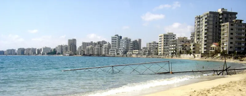 Empty high-rise buildings behind a fenced-off beach in Varosha, Famagusta