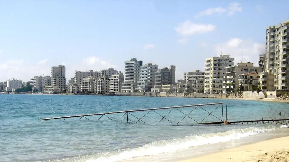 Empty high-rise buildings behind a fenced-off beach in Varosha, Famagusta