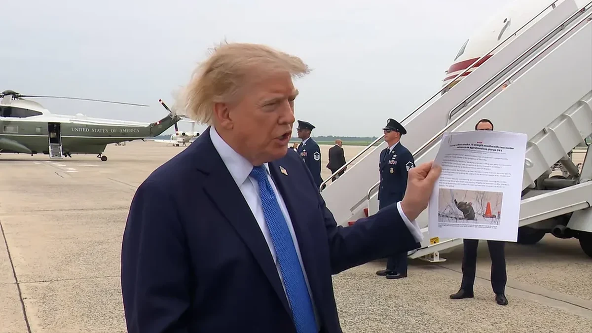 Donald Trump speaks to reporters at Joint Base Andrews, with the presidential helicopter in the background