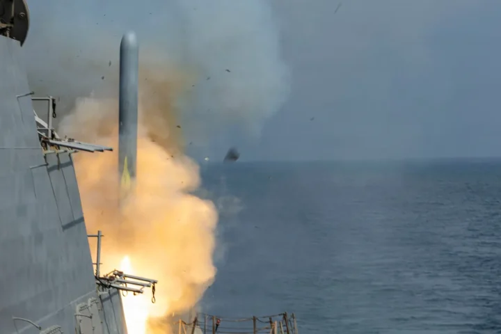 A Tomahawk cruise missile leaves the vertical launching system of the destroyer USS Delbert D. Black in a burst of flame and smoke