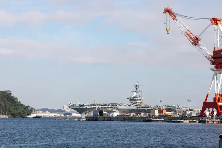 The aircraft carrier USS Theodore Roosevelt arriving at the Yokosuka naval base in Japan