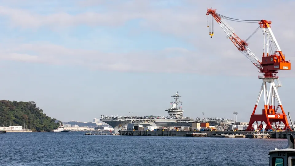 The aircraft carrier USS Theodore Roosevelt arriving at the Yokosuka naval base in Japan
