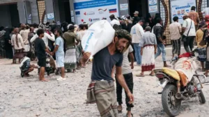 People receive an emergency WFP food distribution in Lahj, Yemen