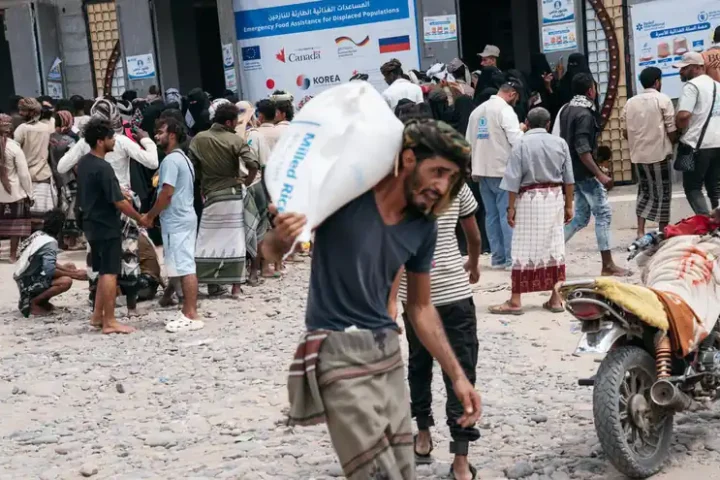 People receive an emergency WFP food distribution in Lahj, Yemen