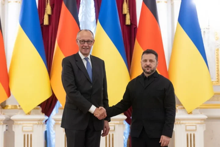 Ukrainian President Volodymyr Zelensky standing with German Chancellor Friedrich Merz in Kyiv